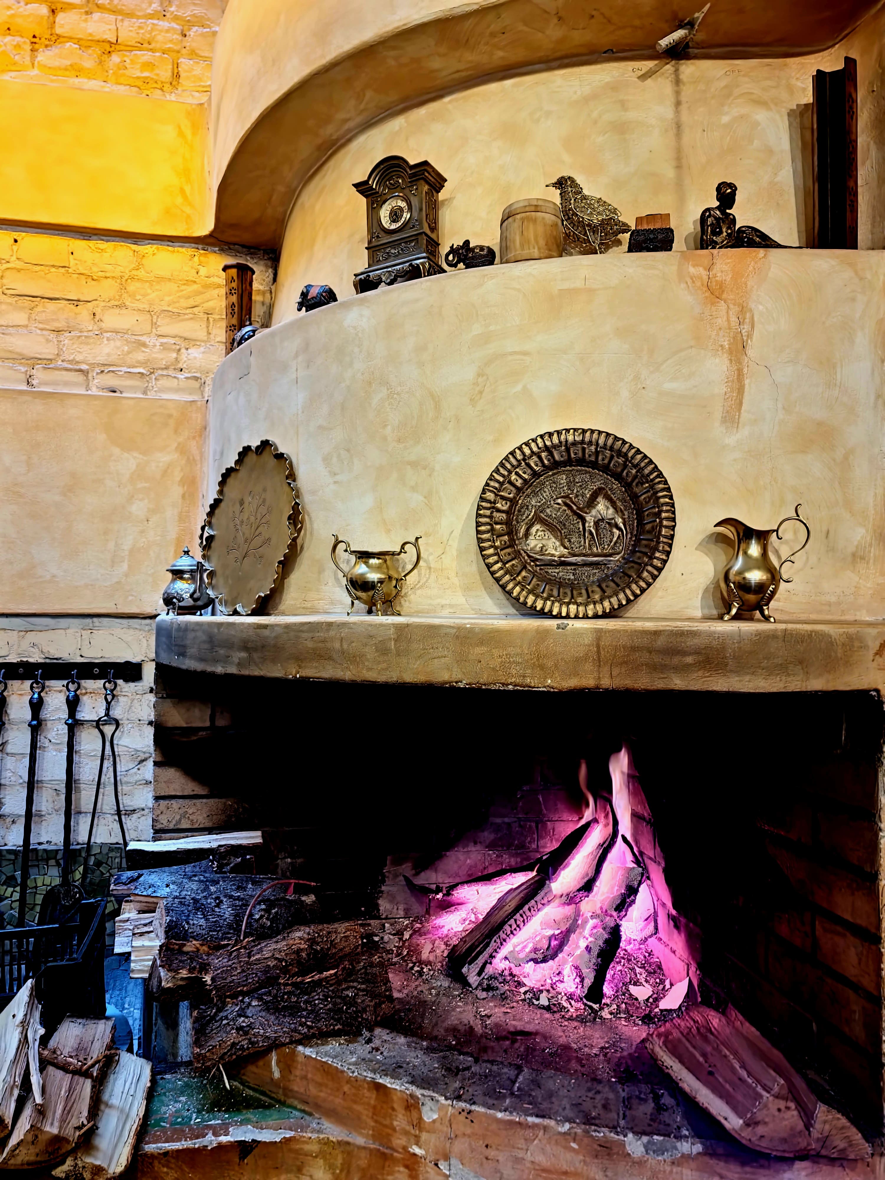 Open fireplace with brass plates above