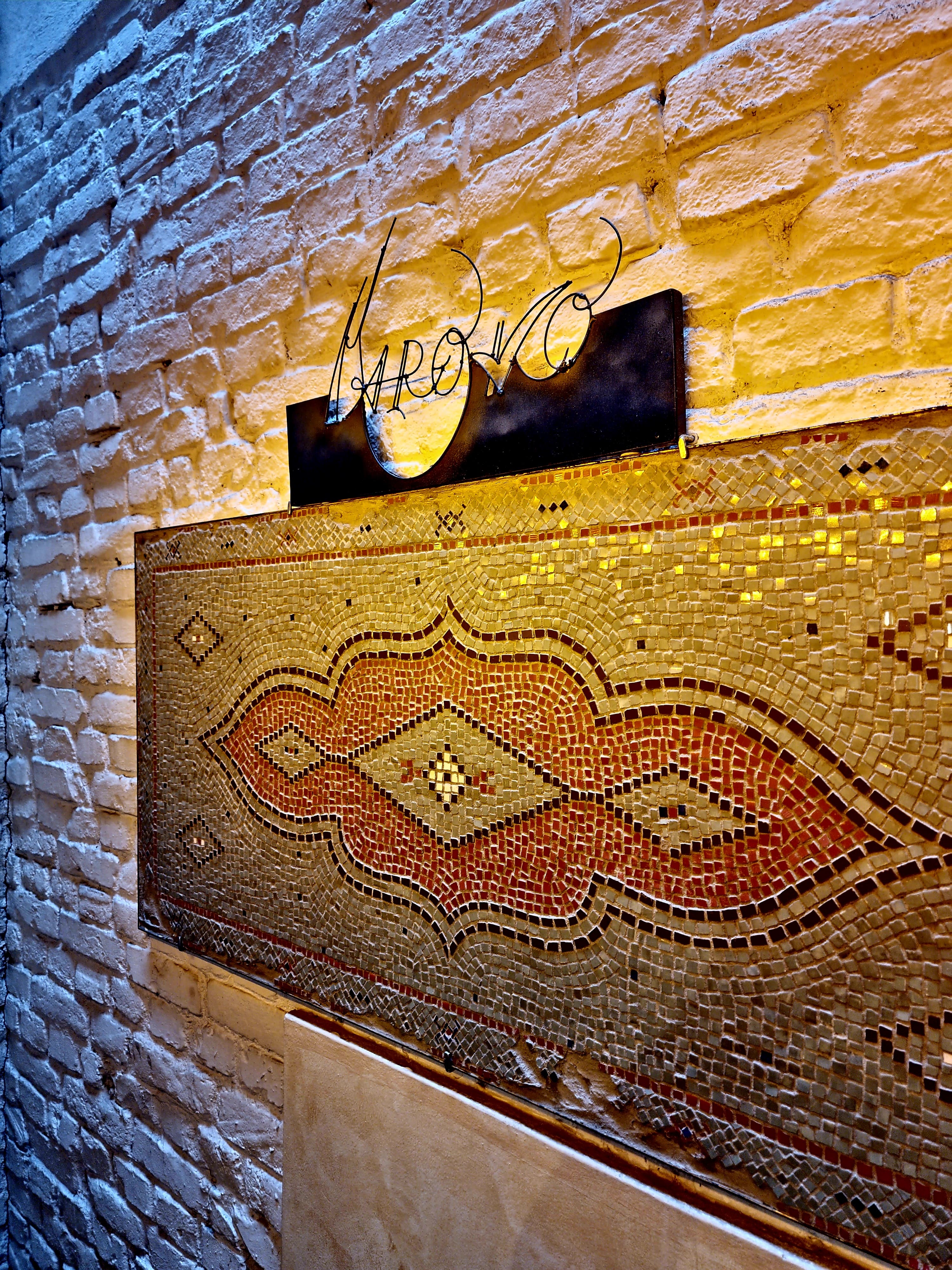 Mosaic Maroko sign on cream brick wall