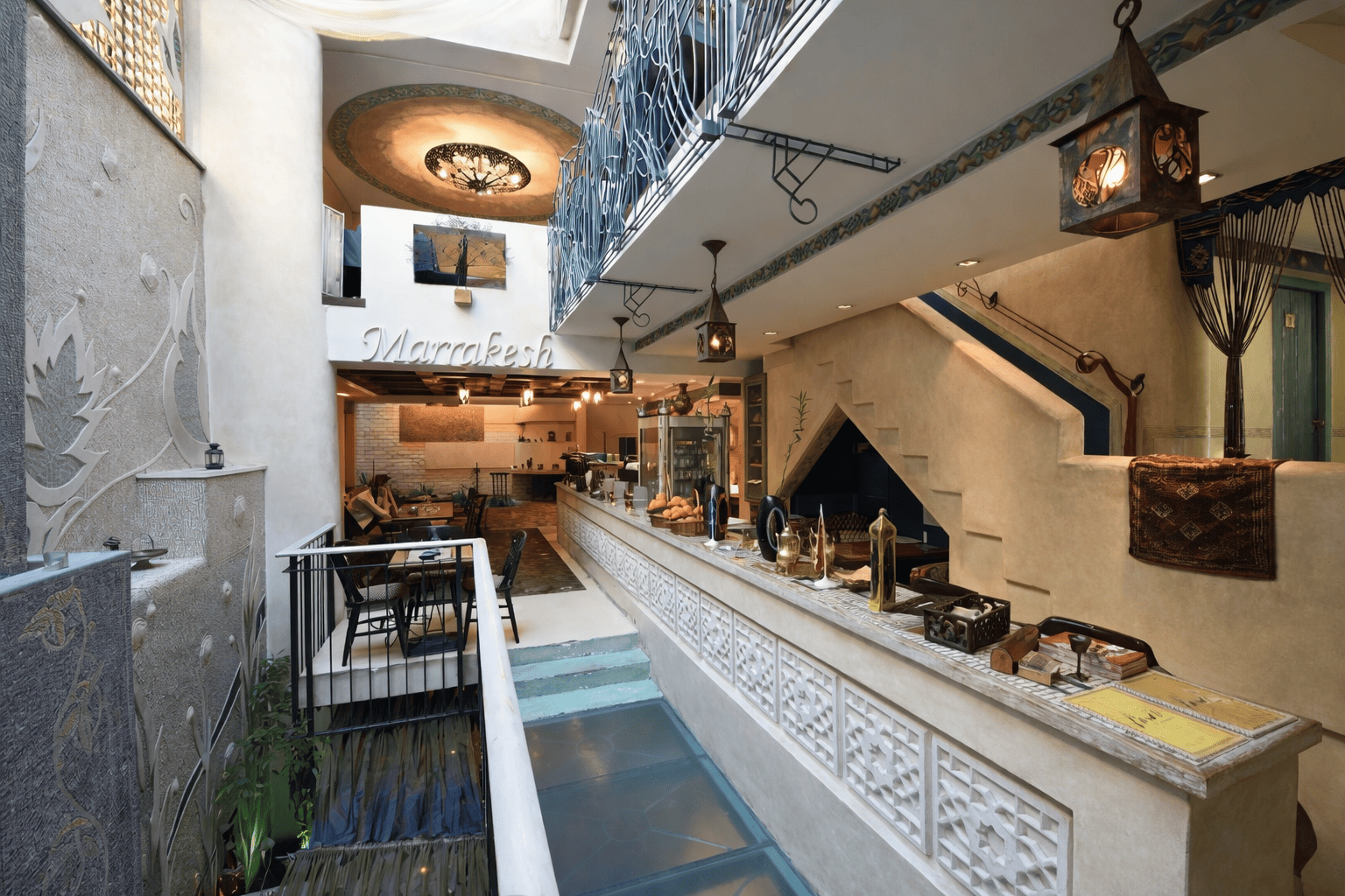 Wide view of the Marrakesh floor with water channel and lanterns